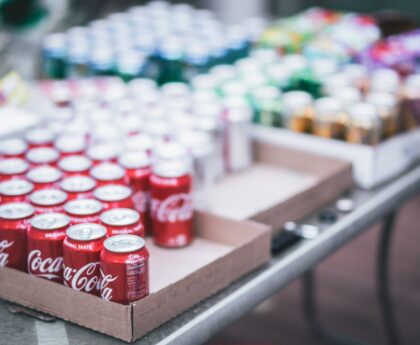 selective focus photography of red coca cola can lot on box